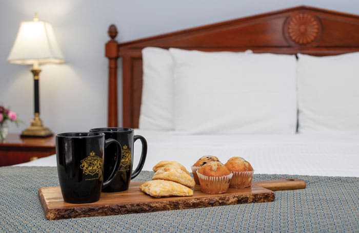 Athenaeum Hotel room with coffee and pastries