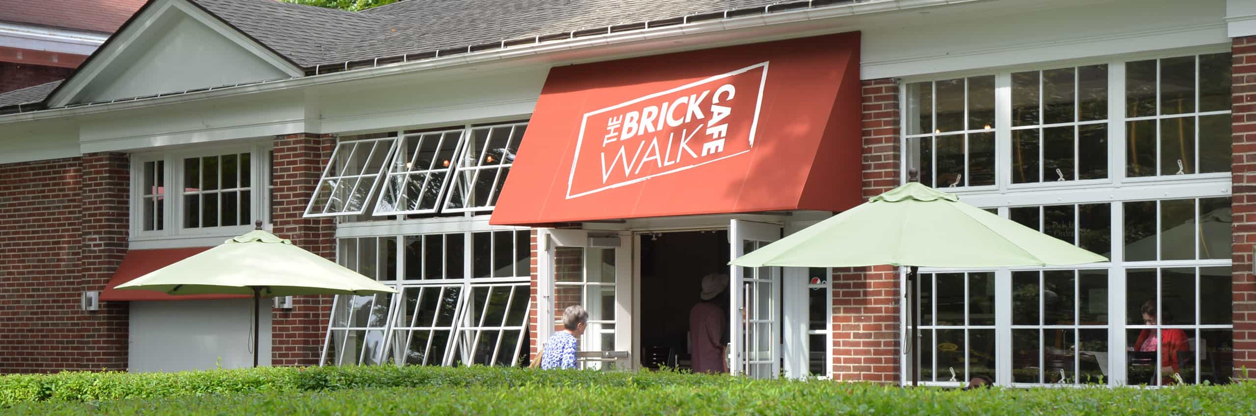 People walking into Brick Walk Cafe
