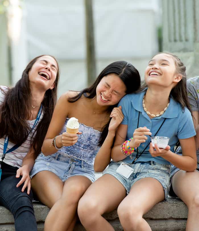 Girls laughing and eating ice cream at the fountain in Bestor Plaza