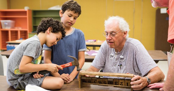 Grandfather and two kids building something in a Special Studies class