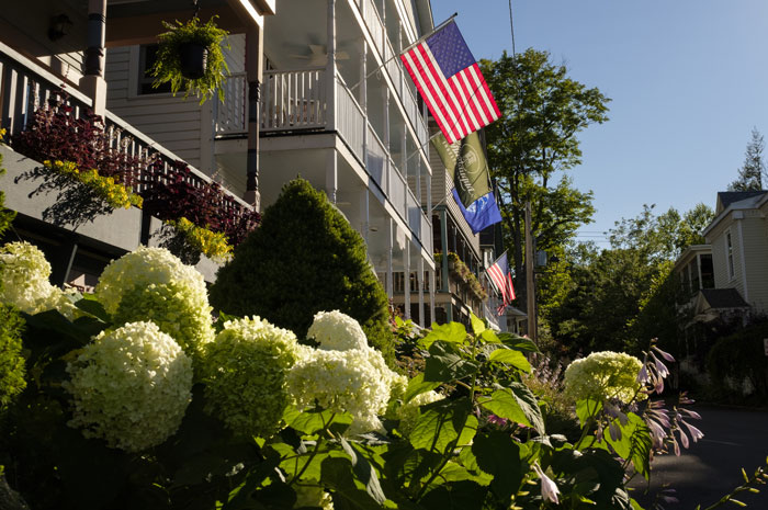 Porches, a garden and American flag at Golden Hour