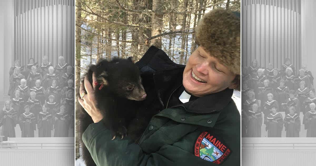 Kate Braestrup holding a bear cub
