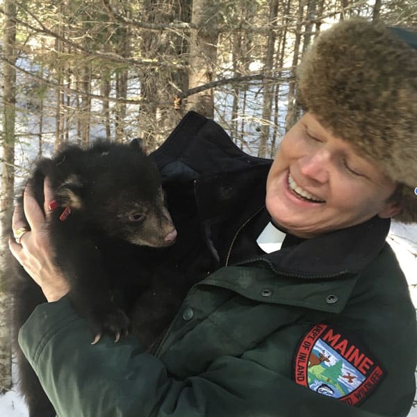 The Rev. Kate Braestrup holding a bear cub