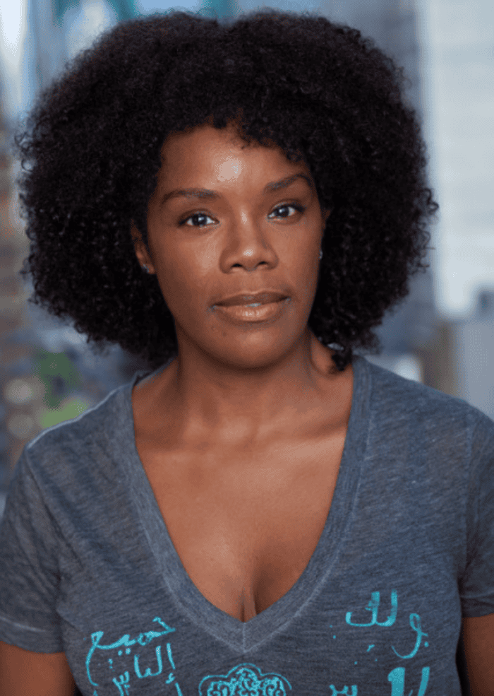 Rosalyn Coleman headshot. She has an afro and is wearing a short sleeve shirt.