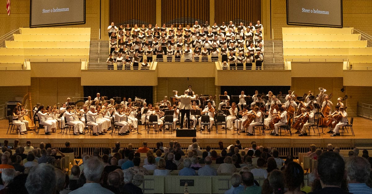 The CSO performing with a choir in the loft behind the stage.