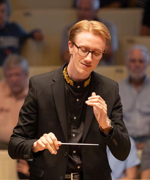 The conducting fellow on stage during a performance