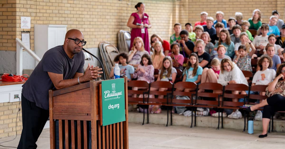 Kwame Alexander standing at a podium during a master class