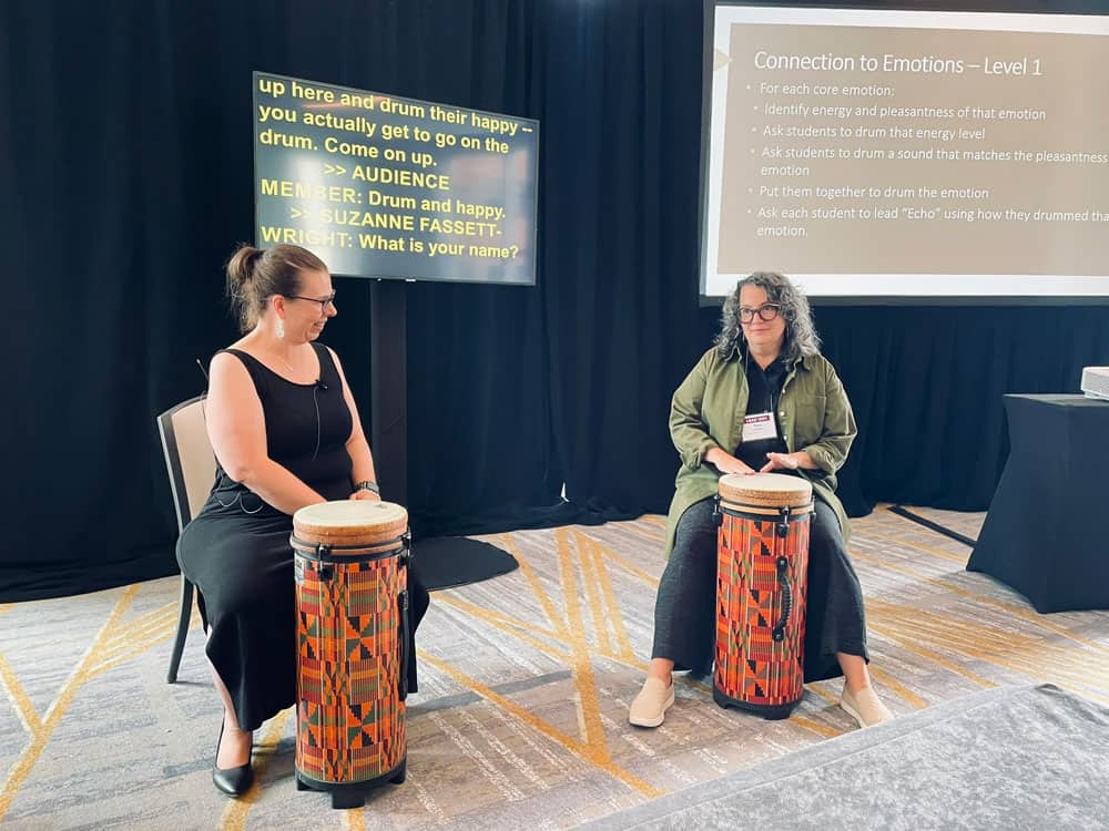 Suzanne Fassett-Wright giving a drumming demonstration at a conference