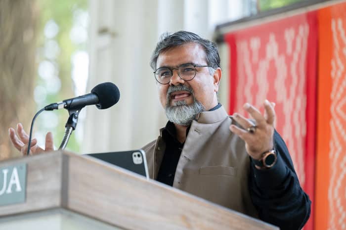 A man wearing black and brown giving a lecture