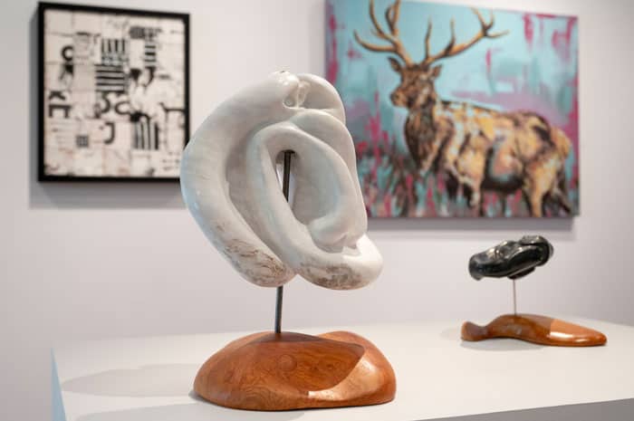 Sculptures and paintings on display in a gallery