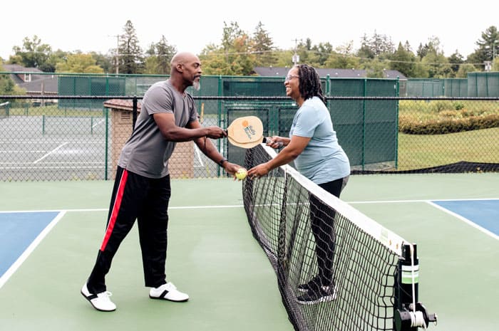 A couple playing pickle ball