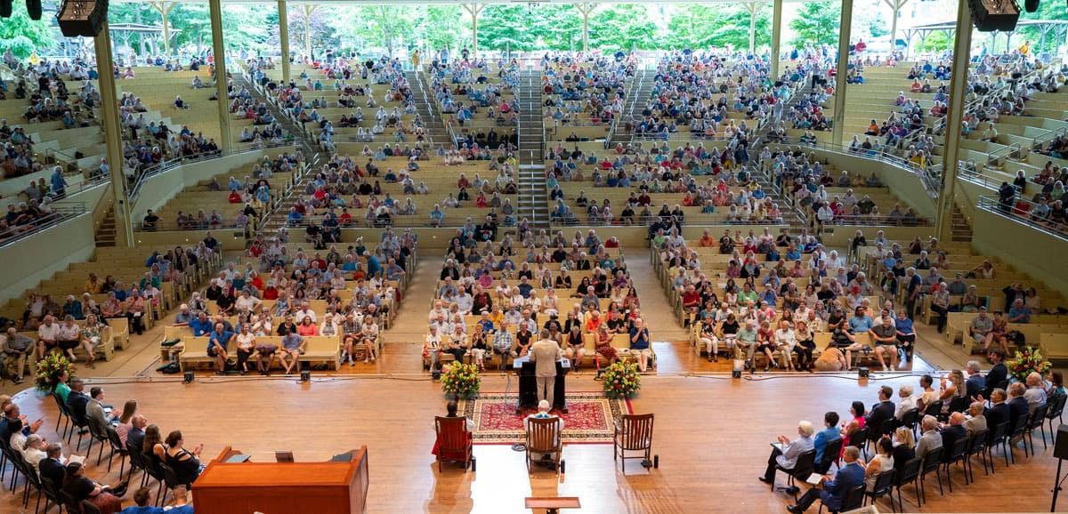 A wide view of people in the Amphitheater listening to the Opening Taps speech