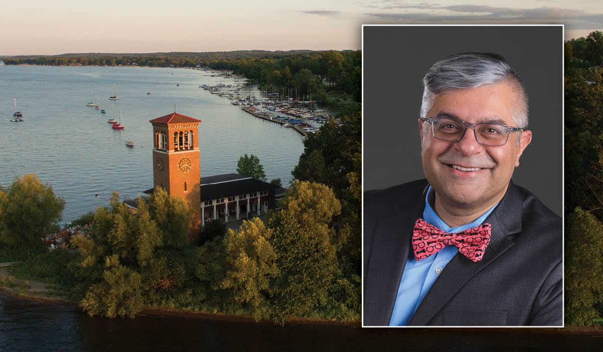 Amit Taneja's headshot over a photo of the bell tower